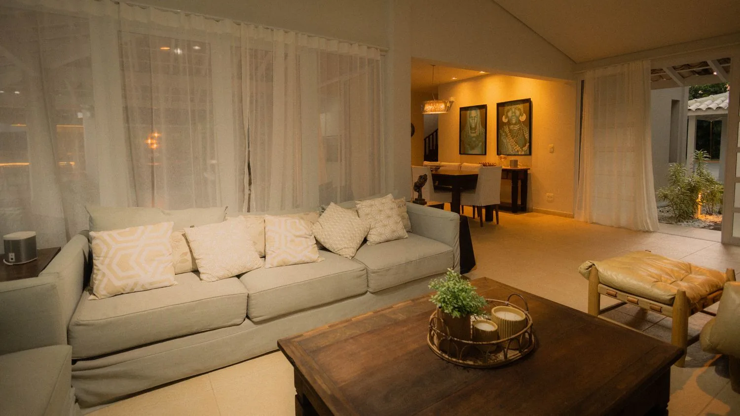 Warm, softly lit Singapore living and dining room set up by Roen