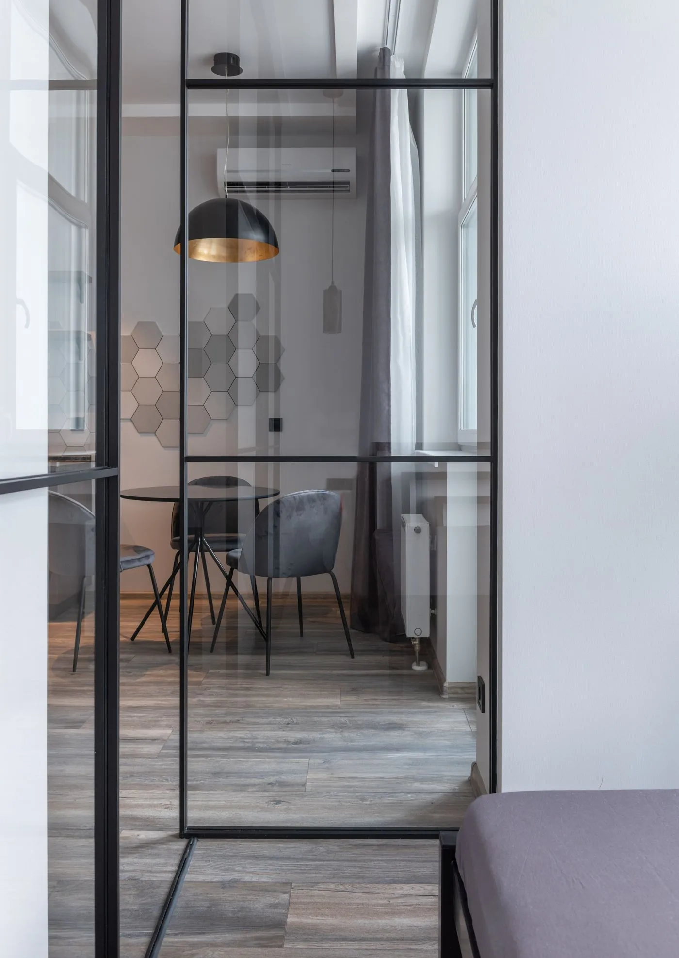 Framed glass partition wall dividing a dining area in a Singapore home