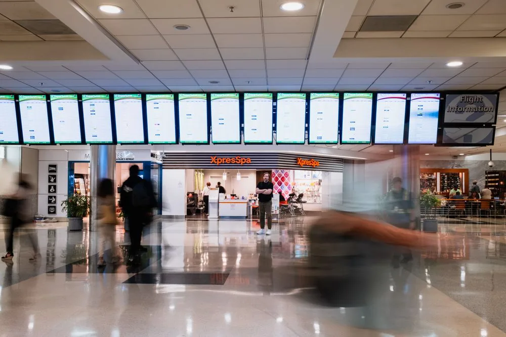 Row of tiled LCD screens showing live information in a public terminal